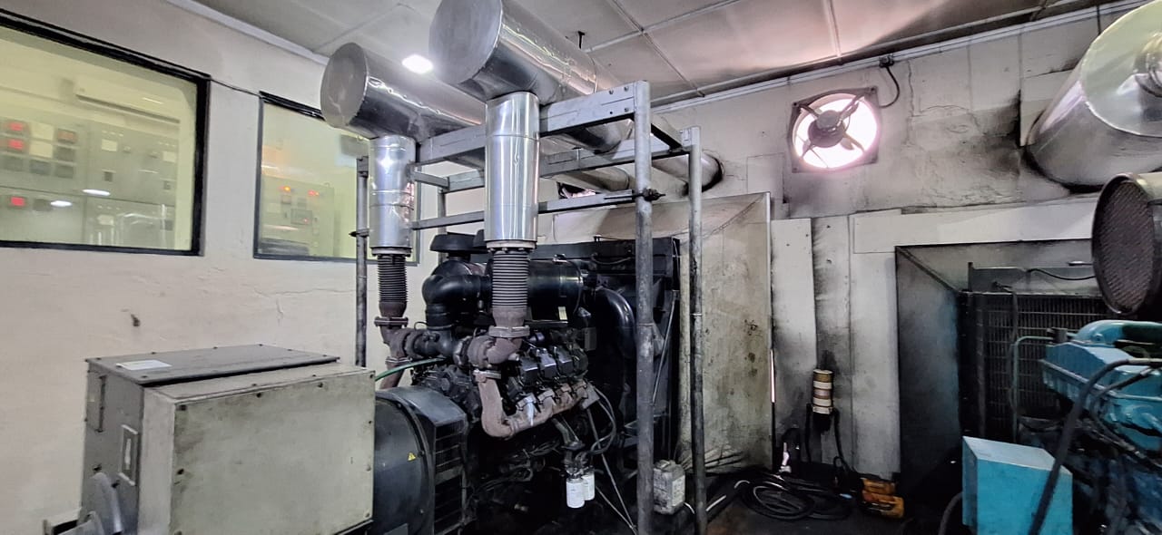 Engine room with stainless-clad exhaust above CAT gensets